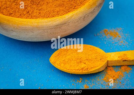 Ground turmeric on blue background Stock Photo - Alamy