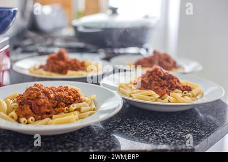 Dishes of homemade macaroni with bolognese sauce Stock Photo