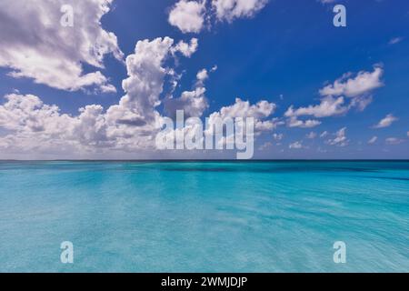 Crystal clear sea water bay. Pristine ocean lagoon sunny cloudy sky, idyllic relax seascape. Transparent surface exotic travel. tropics Mediterranean Stock Photo