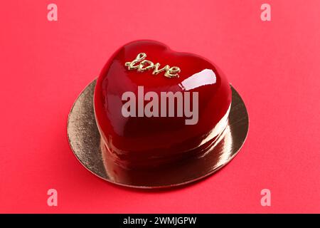 St. Valentine's Day. Delicious heart shaped cake on red background, closeup Stock Photo