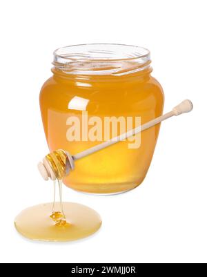 Natural honey dripping from dipper. Jar full of honey on white background Stock Photo