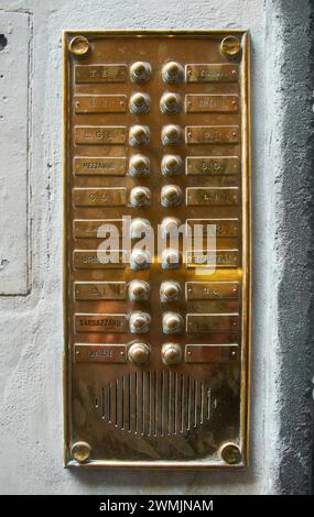 06-11-2013 Florence, Italy - A detailed shot capturing the vintage elegance of a golden antique entrytelephone / Intercom Stock Photo