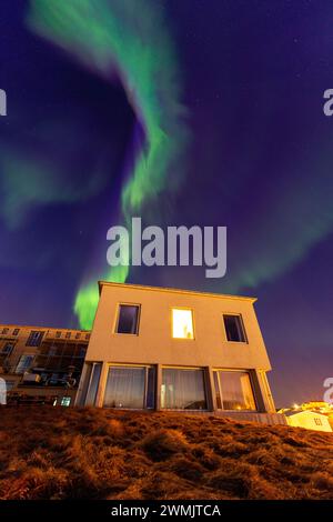 Northern lights over a hotel in Stykkisholmur Stock Photo