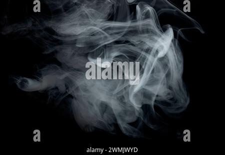 Grey smoke. Cigarette smoke on a black background. Stock Photo
