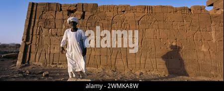 Sudanese man standing next to Egyptian ruins, a Nubian king's tomb from the 25th dynasty. El-Kurru was one of the royal cemeteries used by the Nubi... Stock Photo