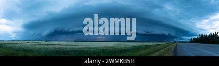 Panorama of supercell thunderstorm clouds over farmland and a country road; Grande Prairie, Alberta, Canada Stock Photo