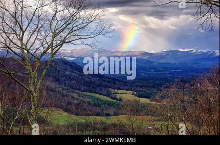 Rainbow shines down on a mountain ridge on a colorful winter morning in North Carolina, USA; Weaverville, North Carolina, United States of America Stock Photo