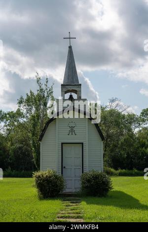 Miniature church in rural Saskatchewan, surrounded by a beautiful green yard; Forget, Saskatchewan, Canada Stock Photo