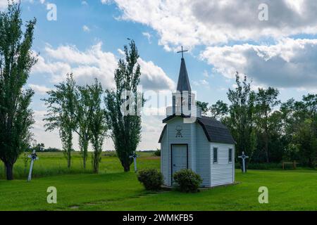 Miniature church in rural Saskatchewan, surrounded by a beautiful green yard; Forget, Saskatchewan, Canada Stock Photo