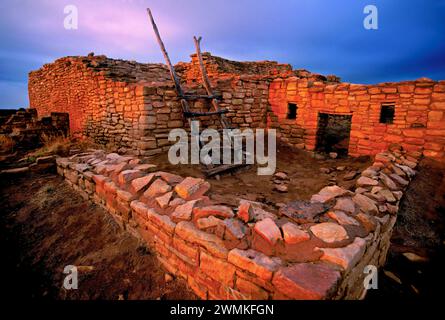 Sunset and shadows fall across a building in Lowry Pueblo, an archeological site located in Canyon of the Ancients National Monument. A treasure of... Stock Photo