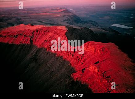 Blazing sunset leaves in shadow the famous gap in Kiger Gorge, atop Oregon's Steens Mountain. Steen's Mountain Wilderness is 'the largest fault-blo... Stock Photo