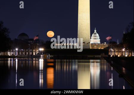 Snow Moon rising over the Reflecting Pool in Washington DC Stock Photo