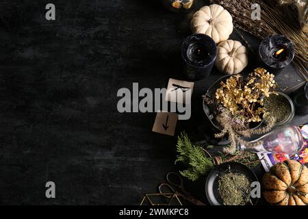 Witch's magic attributes with herbs on dark background Stock Photo - Alamy