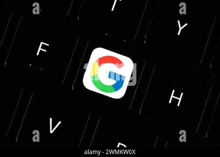 Dallas, TX USA - February 24, 2024: Google colorful G letter on a key on laptop keyboard. Tech giant Google focuses on AI, search, software, and more, Stock Photo