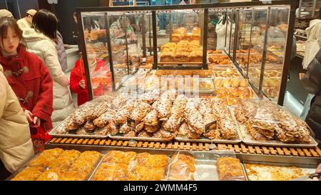 SHANGHAI, CHINA - FEBRUARY 25, 2024 - Consumers line up to buy at GRACE Bakery in Shanghai, China, February 25, 2024. Stock Photo