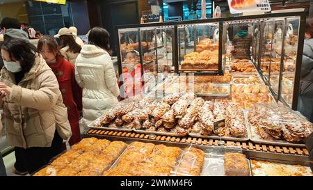 SHANGHAI, CHINA - FEBRUARY 25, 2024 - Consumers line up to buy at GRACE Bakery in Shanghai, China, February 25, 2024. Stock Photo