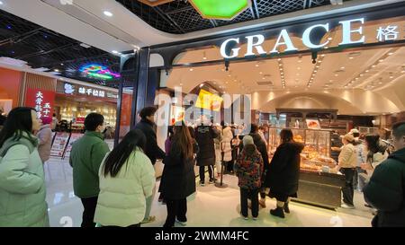 SHANGHAI, CHINA - FEBRUARY 25, 2024 - Consumers line up to buy at GRACE Bakery in Shanghai, China, February 25, 2024. Stock Photo