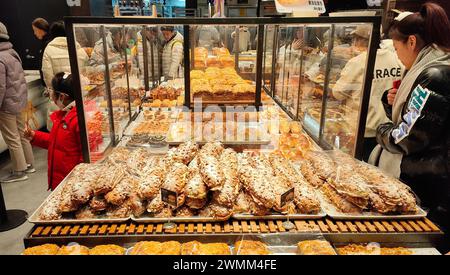 SHANGHAI, CHINA - FEBRUARY 25, 2024 - Consumers line up to buy at GRACE Bakery in Shanghai, China, February 25, 2024. Stock Photo