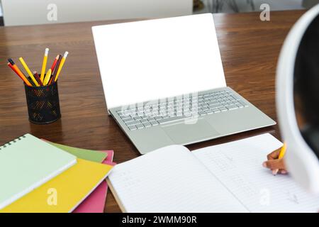 Student engages in online learning at home, with copy space Stock Photo