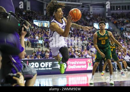 Fort Worth, Texas, USA. 26th Feb, 2024. TCU's MICAH PEAVY (0) attempts to keep the ball in bounds under the TCU basket as BAYLOR's RAYJ DENNIS (10) watches during the second half of play Monday night at Schollmaier Arena on the TCU campus in Fort Worth, Texas. Peavy collided with TCU Sports Broadcasting Department camera man TIM SMITH in the purple shirt knocking him and his chair over. Baylor defeated TCU 62-54 (Credit Image: © Brian McLean/ZUMA Press Wire) EDITORIAL USAGE ONLY! Not for Commercial USAGE! Stock Photo