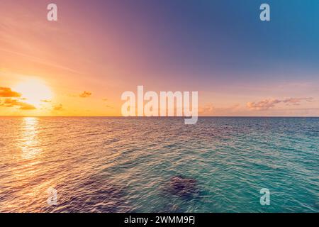 Sea sky clouds, horizon, horizontal background banner. Colorful sunset over evening sea horizon, clouds sky. Tranquil scene. Natural background Stock Photo