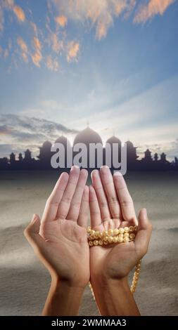 Rosary or prayer beads in a man's hand isolated on white background ...