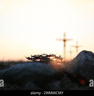 The cross and crown of thorns of Jesus Christ symbolizing suffering and trials on Golgotha Hill, the death of Jesus during Passion Week, and Easter Stock Photo