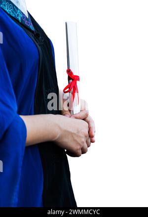 Female student in gown holding a diploma against white background Stock Photo