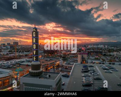 LOS ANGELES - February 2024: The Grove logo at sunset over LA skyline. Aerial view. The Grove is a retail and entertainment complex LA Farmers Market Stock Photo