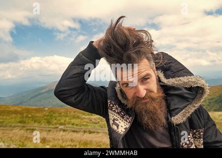 photo of bearded man in the mountain with copy space. bearded man outdoor. bearded man has beard. bearded man having moustache. Stock Photo