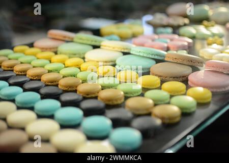 Assorted macarons and pastries displayed on a table Stock Photo