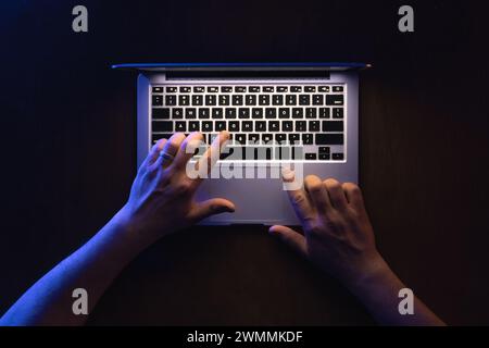 Top view of man hand using laptop at late night. Stock Photo