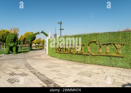 the Tashkent city park lit by sun on a green grass background on a daytime. Stock Photo