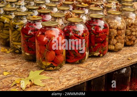 Closeup of canned vegetables in glass jars on the table. Homemade vegetables preserves. Stock Photo