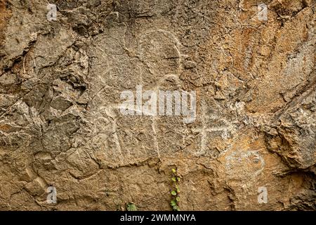 rock animals of deer of ancient people on a stone cliff. Charvak Stock Photo