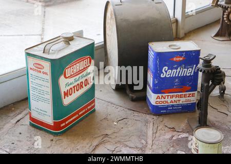vintage cans of Dow sentinel antifreeze coolant and Wearwell motor oil in abandoned garage on route 66 Stock Photo