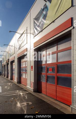 Building with a commercial vehicle repair shop with six garage doors. Modern garage with automatic gates for trucks and large cars. Exterior view.. Stock Photo