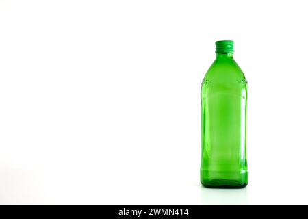 Large green empty glass bottle isolated on white. Stock Photo