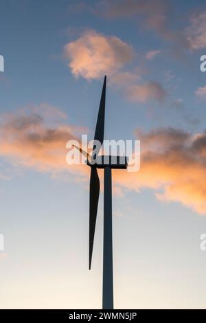 A wind turbine silhouetted against a beautiful evening sky (UK) Stock Photo