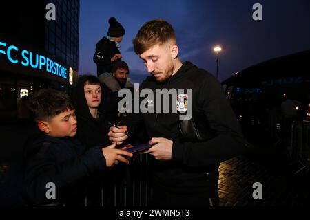 Coventry City's Josh Eccles signs autographs for fans outside the ground before the Emirates FA Cup fifth round match at the Coventry Building Society Arena, Coventry. Picture date: Monday February 26, 2024. Stock Photo