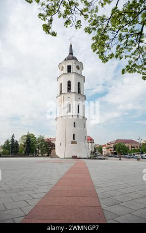 Bell Tower of Vilnius Cathedral. White tower on big empty square. Stock Photo