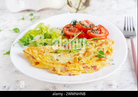 Healthy breakfast.Quesadilla with omelette, bacon  and tomatoes salad. Keto, ketogenic lunch. Stock Photo