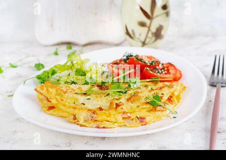 Healthy breakfast.Quesadilla with omelette, bacon  and tomatoes salad. Keto, ketogenic lunch. Stock Photo