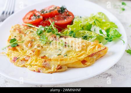 Healthy breakfast.Quesadilla with omelette, bacon  and tomatoes salad. Keto, ketogenic lunch. Stock Photo