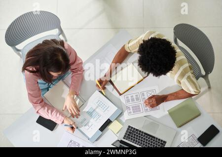 UI and UX designers discussing concept of mobile application Stock Photo