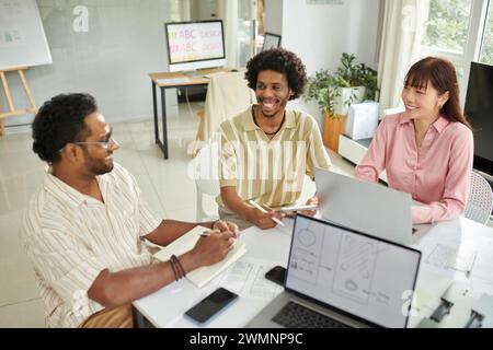 Cheerful creative team meeting to discuss project development Stock Photo