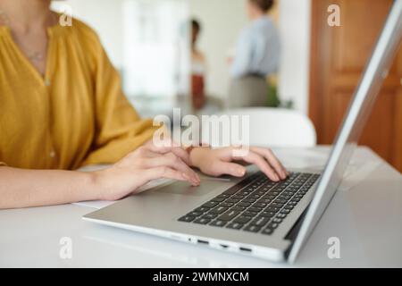 Cropped image of project manager working on laptop at office desk Stock Photo