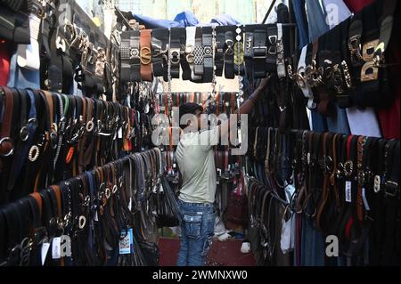 Delhi, New Delhi, India. 27th Feb, 2024. The owner inspects belts at his own shop at Sarojini Market in New Delhi, India on 27 February, 2024 (Credit Image: © Deep Nair/ZUMA Press Wire) EDITORIAL USAGE ONLY! Not for Commercial USAGE! Stock Photo