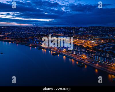 Aerial view of the illuminated waterfront and harbor at night ...