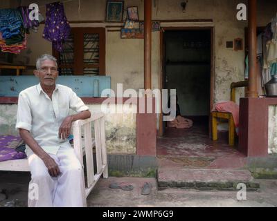 India, Kerala, Cochin: an Indian couple on the doorstep of their home Stock Photo